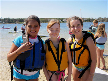 Three girls enjoying stand up and paddle fun at Paddle for the Bays event
