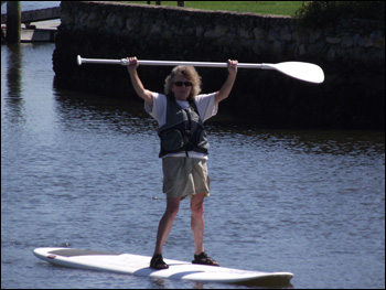 Fun for all ages. Woman doing stand up and paddle on Cape Cod.
